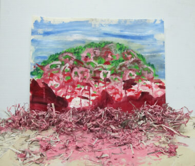An abstract landscape with blue sky and shredded pink, red and green land