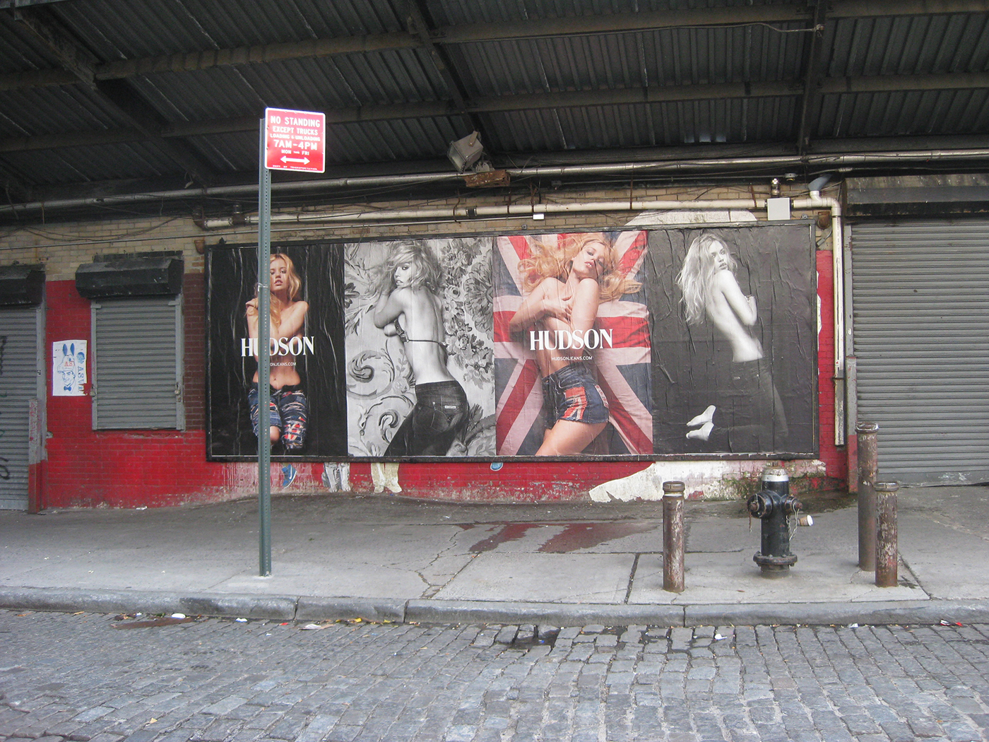A large billboard in the meatpacking district advertising clothes showing 4 panels with photos of topless women