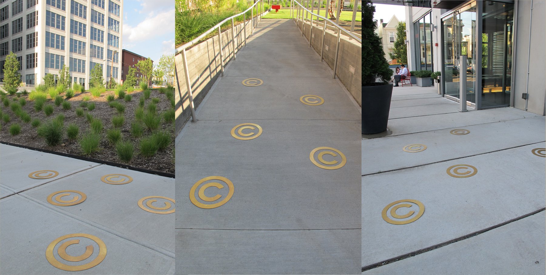 Gold copyright symbols spread along concrete walkways around new luxury buildings