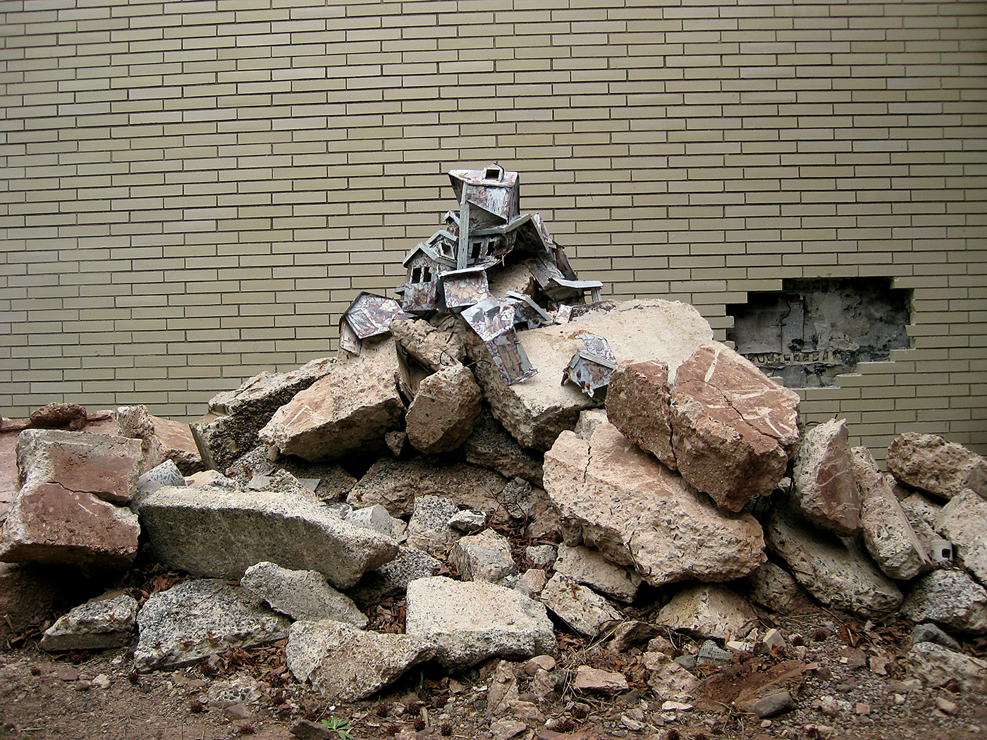 Broken cardboard playhouse displayed in piles of rubble