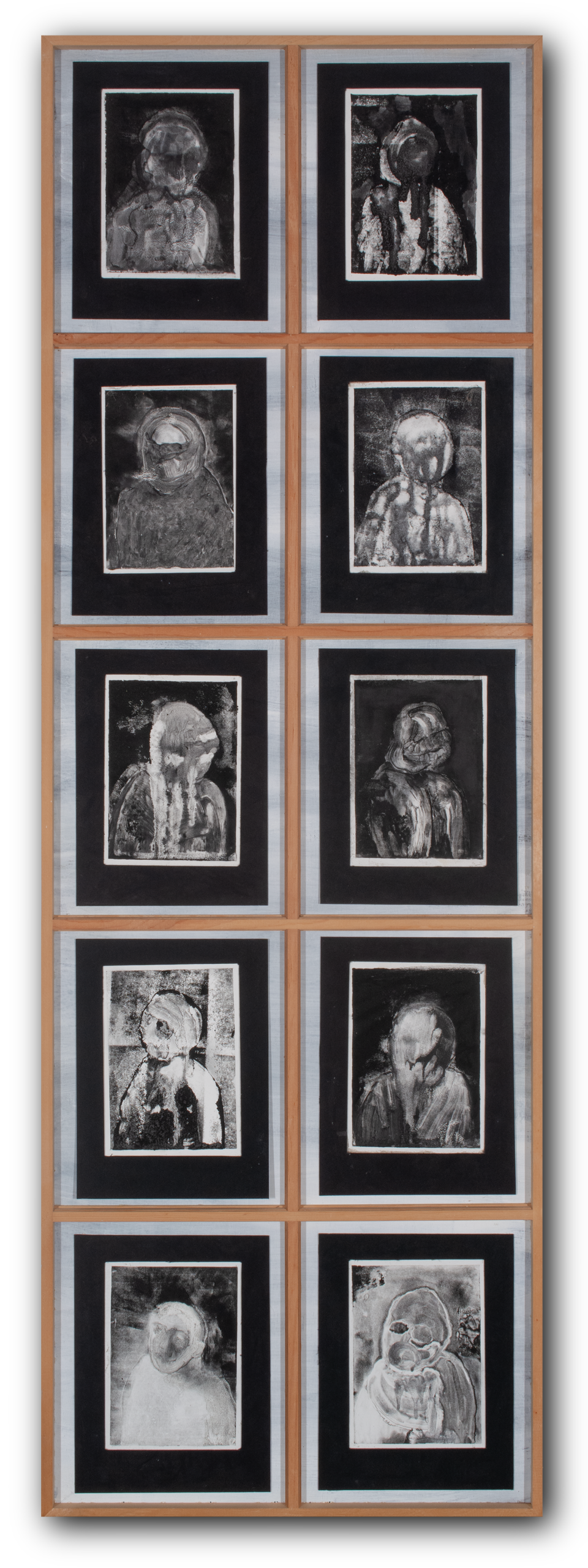 10 black and grey monotype prints of portraits fading in and out of legibility mounted in wooden window panes.