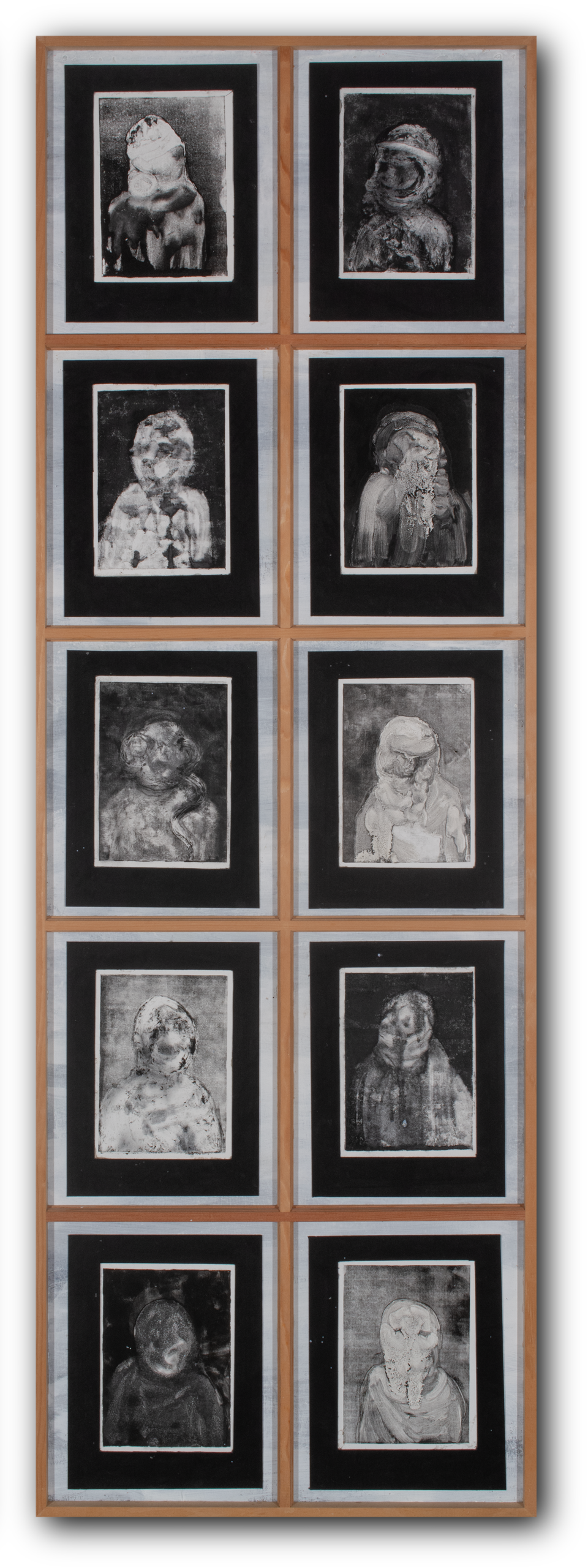 10 black and grey monotype prints of portraits fading in and out of legibility mounted in wooden window panes.